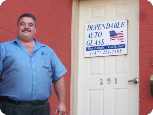 Mike Lester, owner of Dependable Auto Glass standing in front of the shop