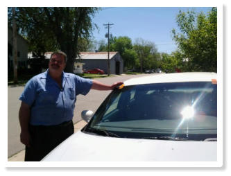 Mike smiling next to a car with a newly installed windshield